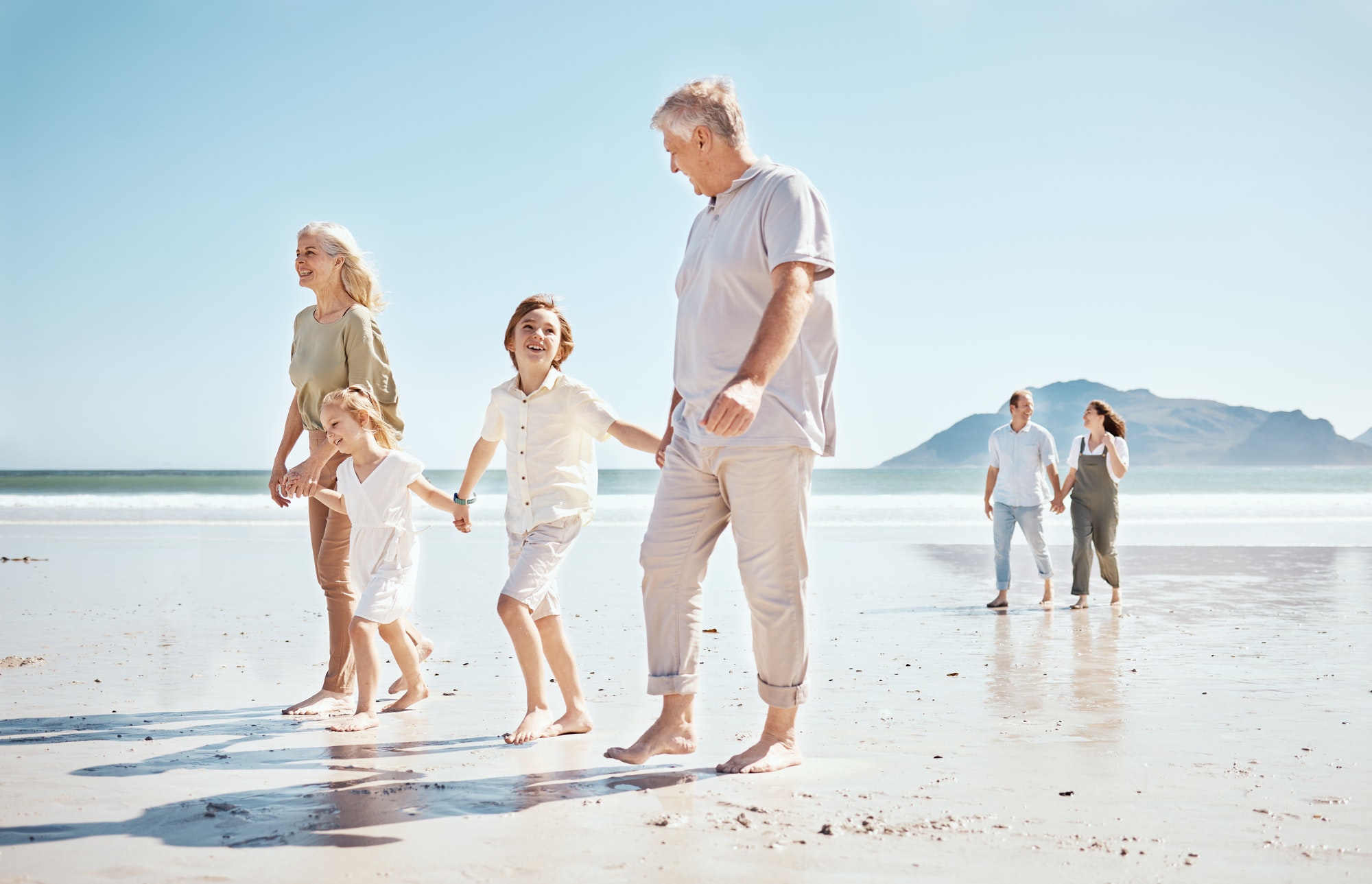 Grandparents, kids and holding hands on beach, family and parents with trust and support, tropical